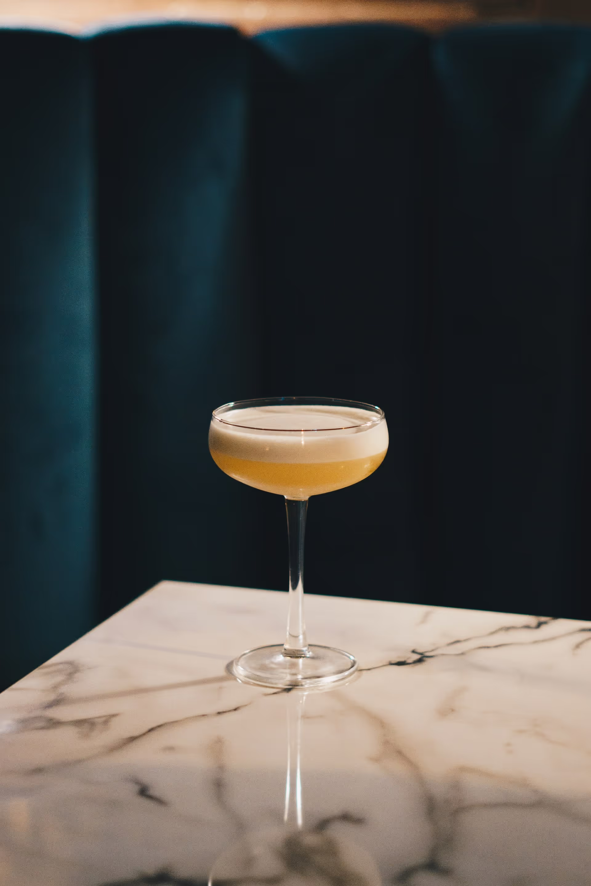 Whiskey tumbler on dark bar