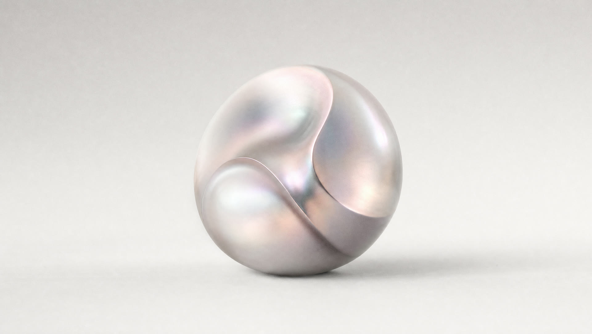 A sculptural iridescent form in soft studio light