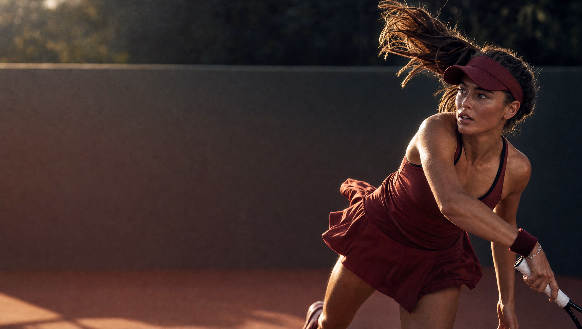 Tennis player mid-serve on a sunlit court