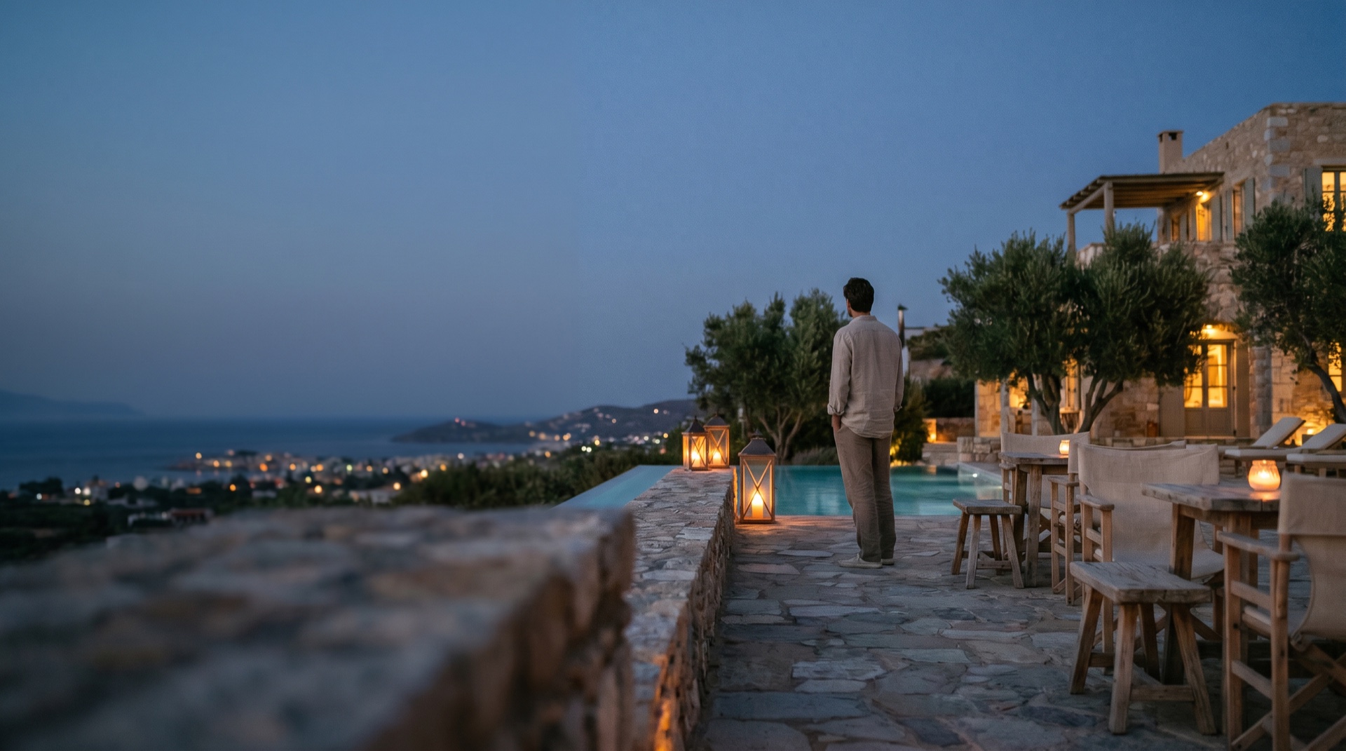 A destination at blue-hour dusk, warm lights against the sky