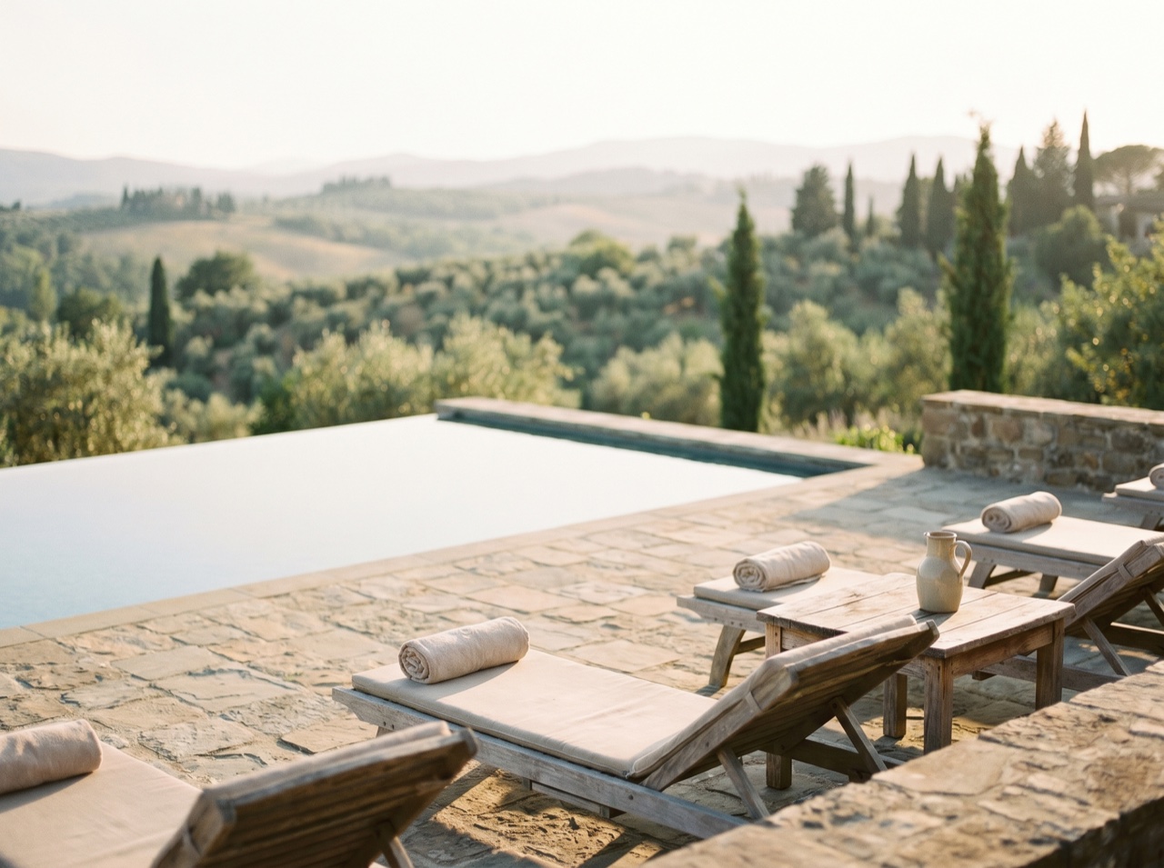 A villa pool and terrace at golden hour, the outlook