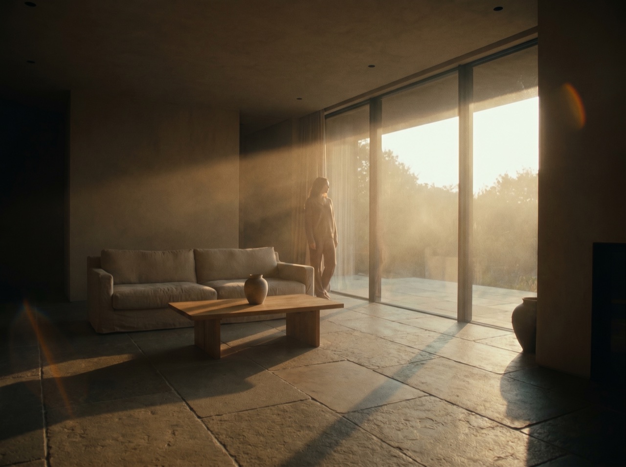 An agent photographing a sunlit modern living room for a listing