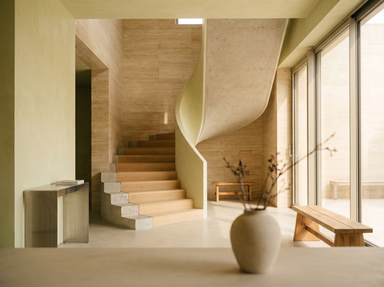 A sculptural concrete and timber interior in soft light