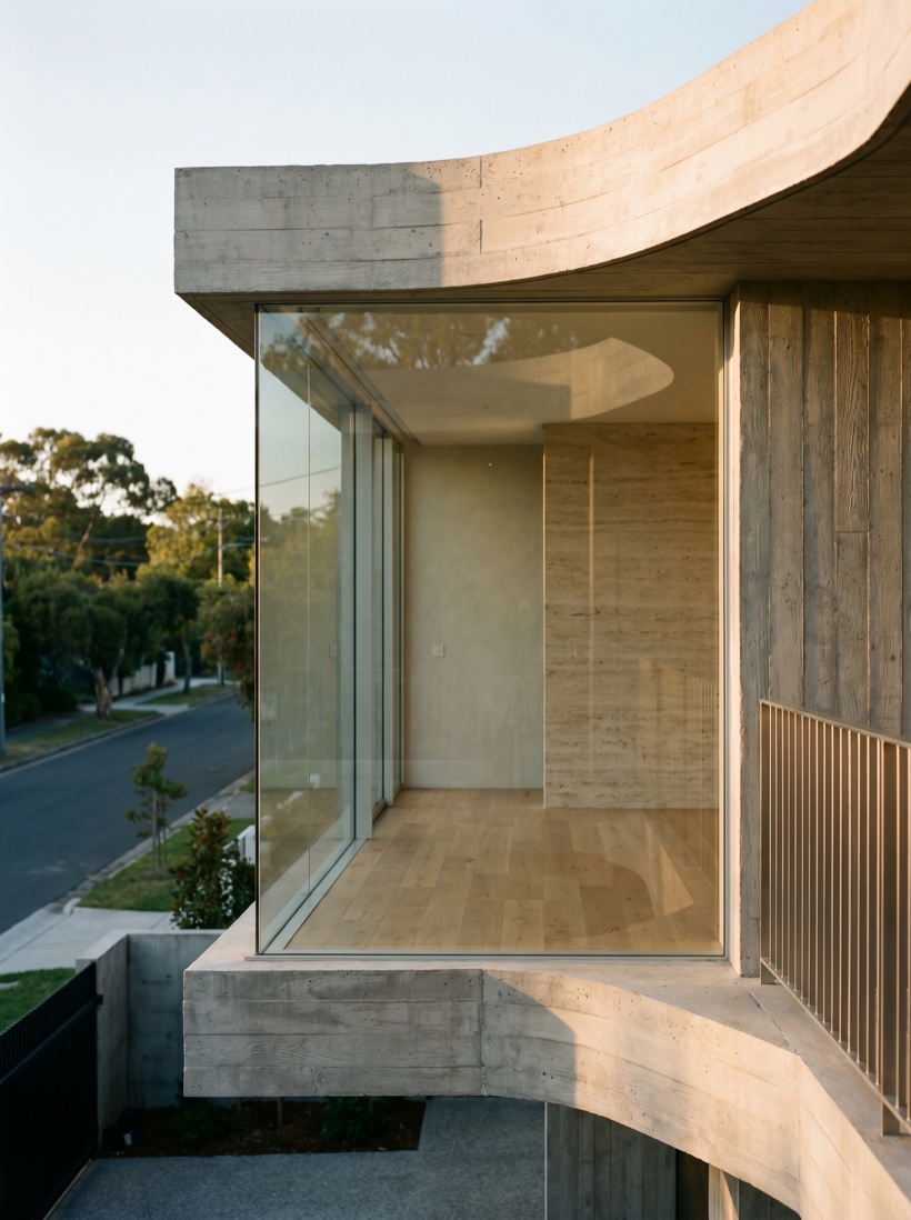 A striking contemporary building detail in raking light, concrete and glass, architectural and restrained