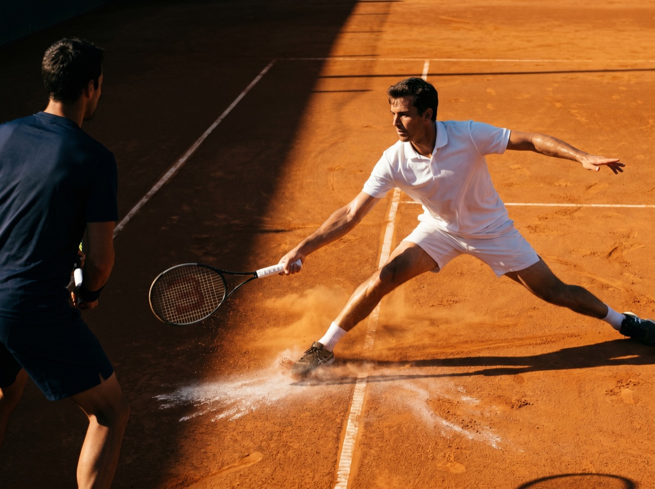 A clean rally captured at full stretch on court