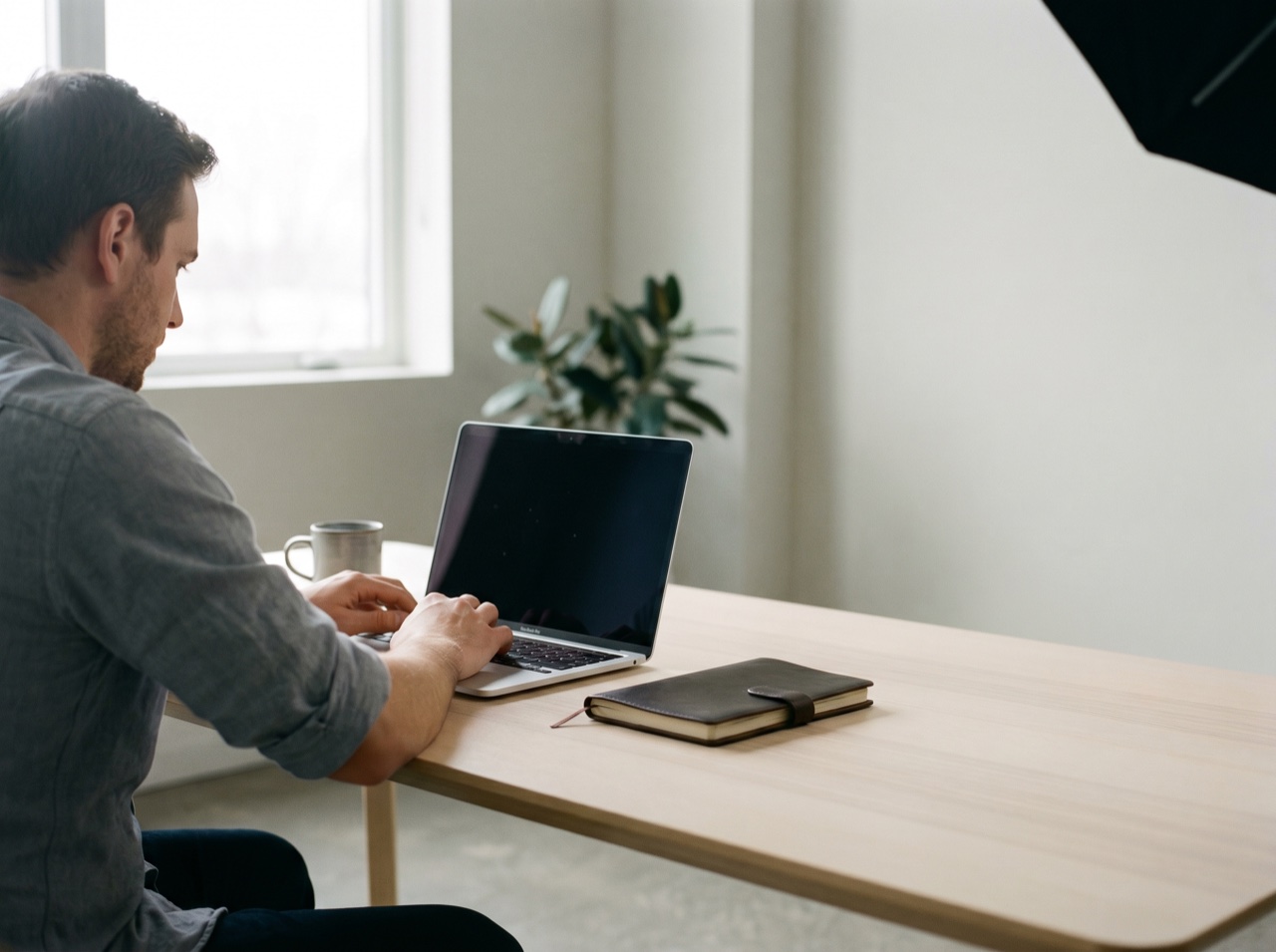 A founder at a focused workspace in soft light